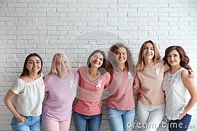 Group of women with silk ribbons near brick wall Stock Photo