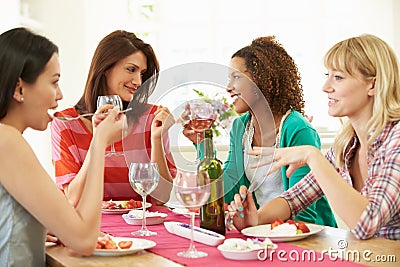 Group Of Women Sitting Around Table Eating Dessert Stock Photo