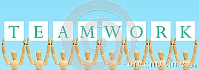 Group of wooden figure standing and holding text label in words Teamwork. Stock Photo