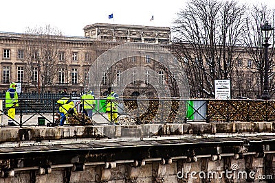 Group of workers removing padlocks at Pont Neuf in Paris Editorial Stock Photo