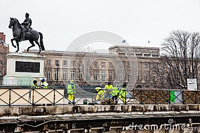 Group of workers removing padlocks at Pont Neuf in Paris Editorial Stock Photo