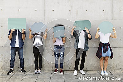 Group of young adults outdoors holding empty placard copyspace t Stock Photo