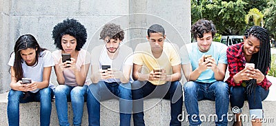 Group of young adults playing online game with phone Stock Photo