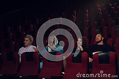 Group of young adults watching movie in theater Stock Photo