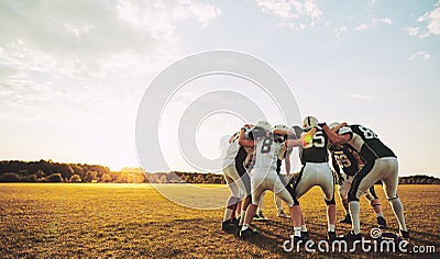 American football players in a huddle during practice Stock Photo