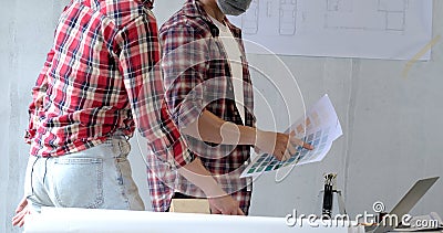 Group of young asian of engineer chooses the perfect color for a new house and pointing laptop Stock Photo