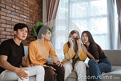 Group of young Asian sitting together on the couch looked disappointed Stock Photo