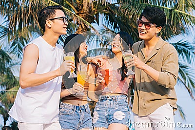 A group of young asians enjoy a trip to the sea on a summer vacation Stock Photo