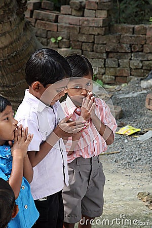 A group of young Bengali Catholics pray before a statue of the Blessed Virgin Mary in Bosonti, India Editorial Stock Photo