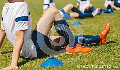 Group of Young Boys on Stretching Outdoor Session with Foam Rollers. Soccer Football Players in a Team on Fitness Workout Stock Photo