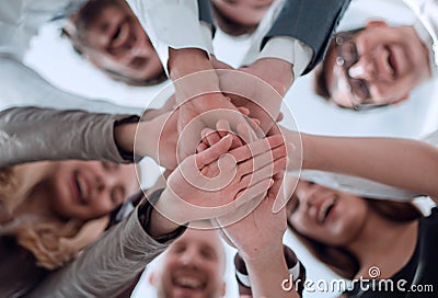 group of young business men clasping their hands together Stock Photo