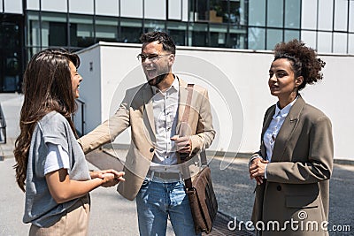 Group of young business people, job candidates standing in front of the office building waiting to be called to meeting with the Stock Photo