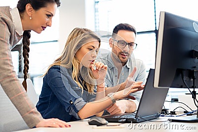 Group of business people and software developers working as a team in office Stock Photo