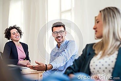 Group of young businesspeople working together in a modern office. Stock Photo