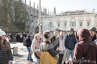 Group of young Chinese tourists seen in a group outside the famous Kings College. Editorial Stock Photo