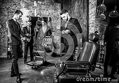 Group of young elegant positive mens pose in interior of barbershop. Stock Photo