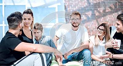 Group of young entrepreneurs sit on the floor in the new office Stock Photo