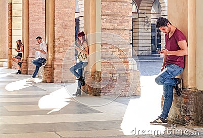 Group of young fashion friends using smartphone in urban area Stock Photo