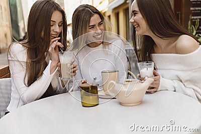 Girlfriends have fun in cafe Stock Photo