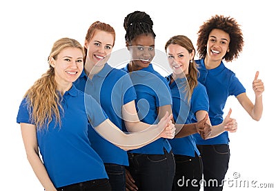 Group Of Young Female Janitors Gesturing Thumbs Up Stock Photo