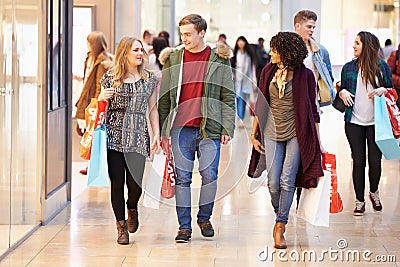 Group Of Young Friends Shopping In Mall Together Stock Photo