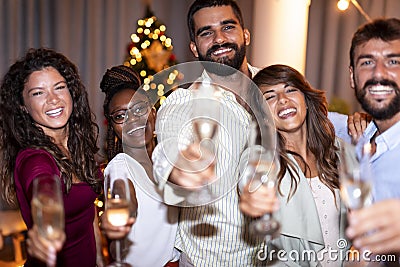 Friends making a toast at New Years Eve party midnight countdown Stock Photo