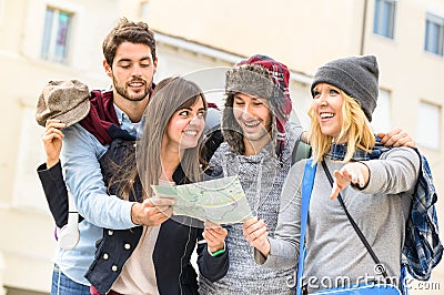 Group of young hipster tourists friends cheering with city map Stock Photo