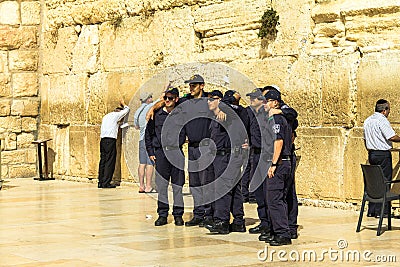 A group of young Israelis in police uniform are doing a picture in memory of the visit to the Wailing Wall Editorial Stock Photo