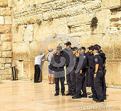 A group of young Israelis in police uniform are doing a picture in memory of the visit to the Wailing Wall Editorial Stock Photo