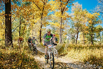 Group Of Young Mountain Bike Cyclist Riding Track At Sunny Day. Editorial Stock Photo