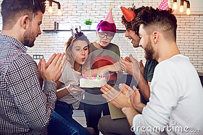 A group of young people with birthday cake indoors. Stock Photo