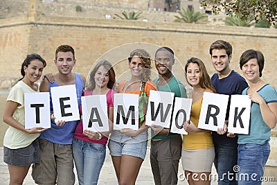 Group of young people holding teamwork sign Stock Photo