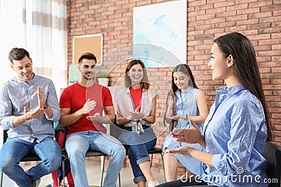 Group of young people learning sign language with teacher Stock Photo