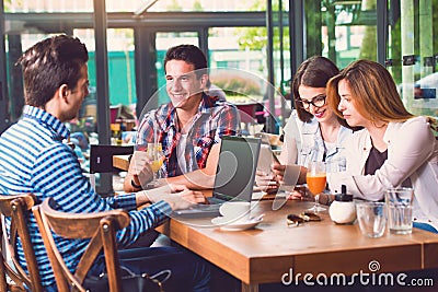 Group of young people sitting at a cafe, talking Stock Photo