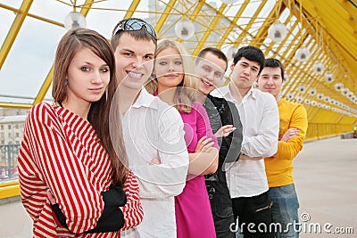 Group of young people stand on footbridge Stock Photo