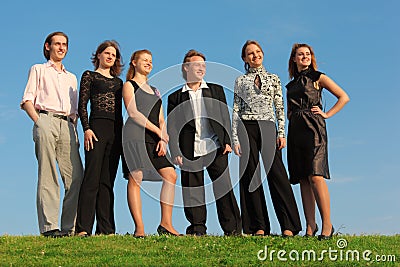 Group of young people stand on meadow Stock Photo