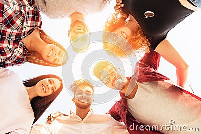 Group of young people standing in a circle, outdoors Stock Photo