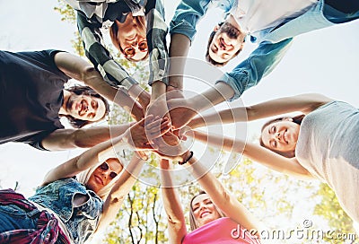 Group of young people standing in a circle, outdoors Stock Photo