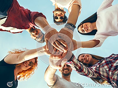 Group of young people standing in a circle, outdoors Stock Photo