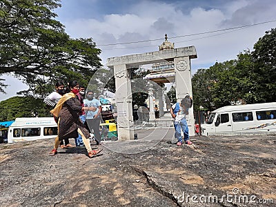 Group of Young people standing at entrance rock or stone of the Gavi Gangadareshwara Temple and a Protected Ancient Monument Editorial Stock Photo