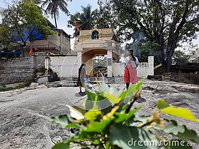 Group of Young people standing at entrance rock or stone of the Gavi Gangadareshwara Temple and a Protected Ancient Monument Editorial Stock Photo