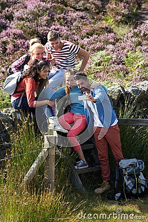 Group Of Young People Taking Photograph On Hike Stock Photo