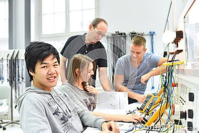 Group of young people in technical vocational training with teacher Stock Photo