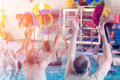 Group or young and senior people in aquarobic fitness swimming pool exercising Editorial Stock Photo