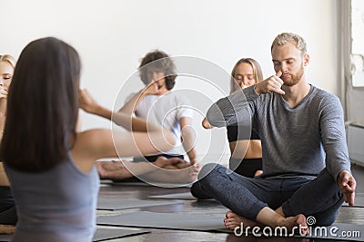 Group of young sporty people making Alternate Nostril Breathing Stock Photo