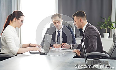 Group of young successful businessmen lawyers communicating together in a conference room while working on a project Stock Photo