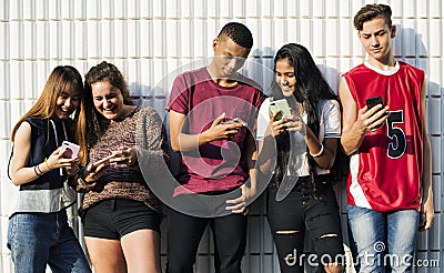 Group of young teenager friends chilling out together using smartphone social media concept Stock Photo