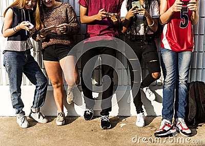 Group of young teenager friends chilling out together using smartphone social media concept Stock Photo