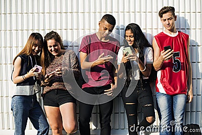 Group of young teenager friends chilling out together using smartphone social media concept Stock Photo