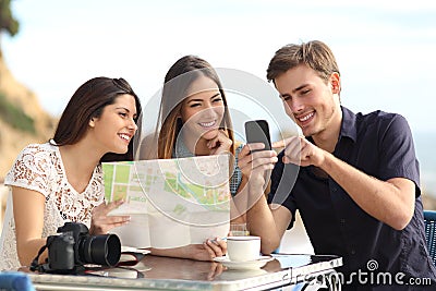 Group of young tourist friends consulting gps map in a smart phone Stock Photo